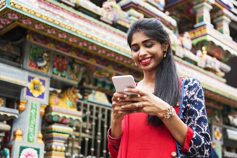 Young lady using mobile internet on phone