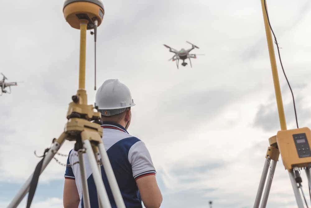 Drone surveying on location with a GPS device in the frame