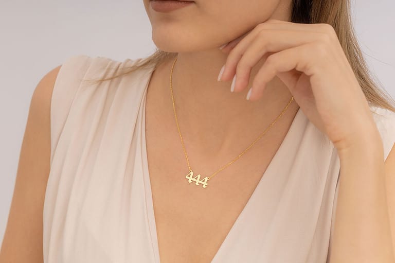 A woman wearing an elegant angel number necklace