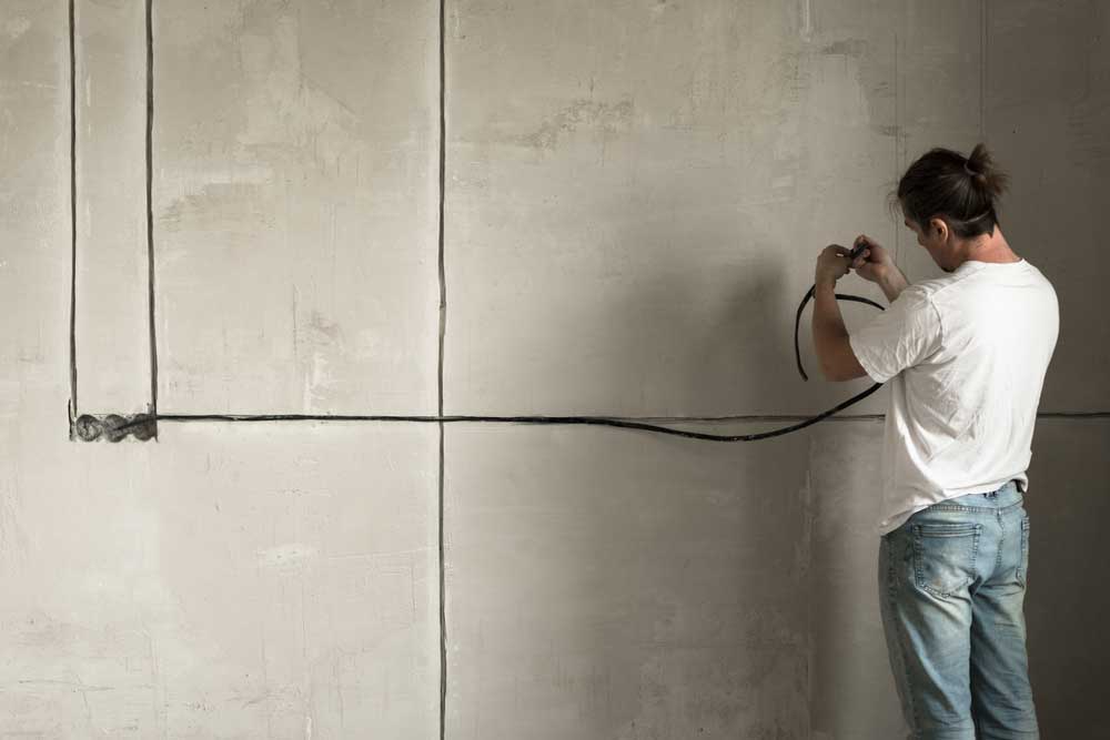 Routing a cable on the wall