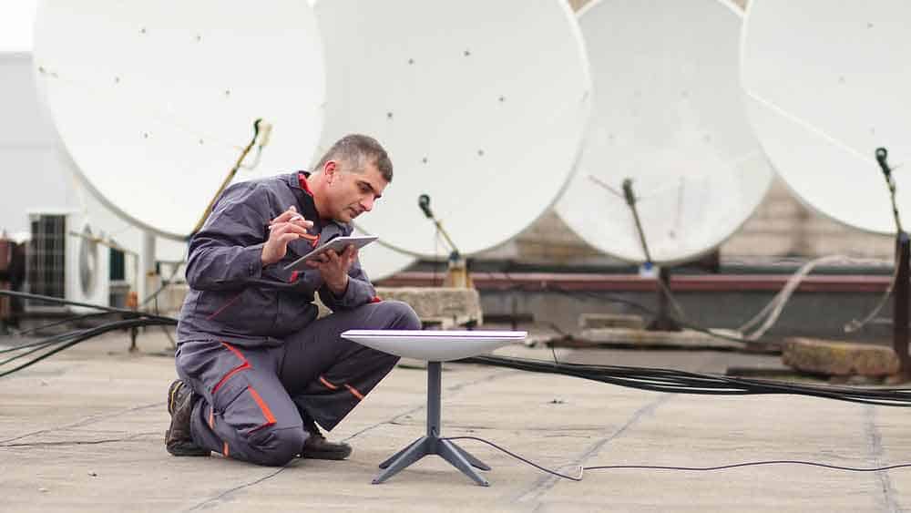 Man installing the Starlink Antenna